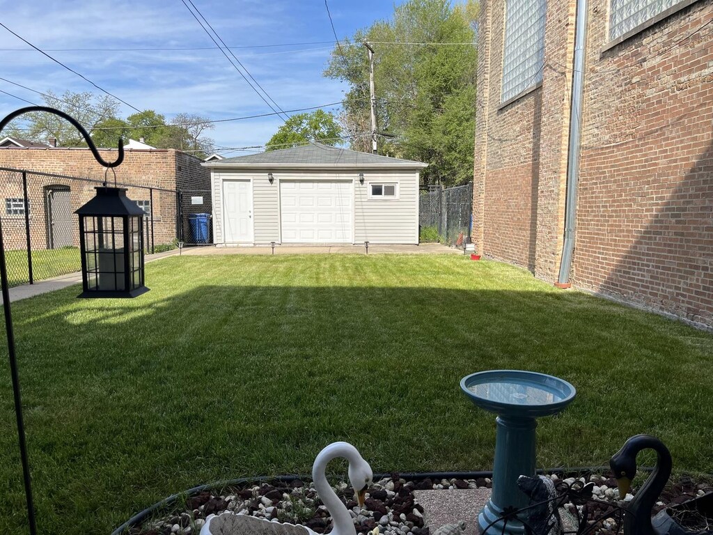 7146 S Calumet Ave, Chicago, IL 60619 - view of yard featuring a garage and an outdoor structure