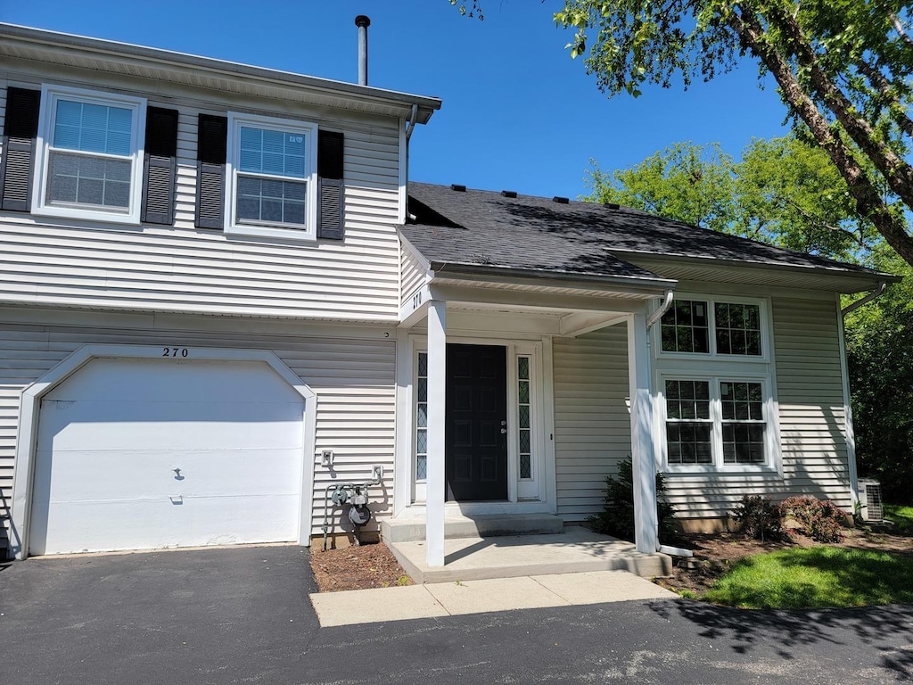 270 Butternut Ln, Streamwood, IL 60107 - view of front of house featuring an attached garage and driveway