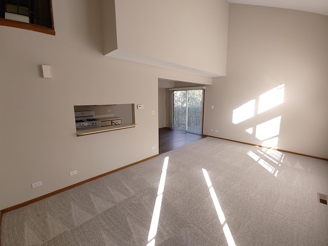 270 Butternut Ln, Streamwood, IL 60107 - unfurnished living room featuring carpet flooring, baseboards, and a towering ceiling