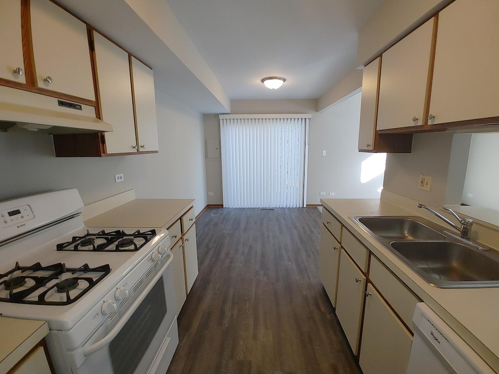 270 Butternut Ln, Streamwood, IL 60107 - kitchen with white appliances, under cabinet range hood, a sink, dark wood-style floors, and light countertops