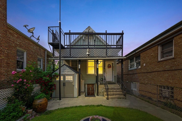 5512 W Wrightwood Ave, Chicago, IL 60639 - back of house at dusk featuring a storage unit