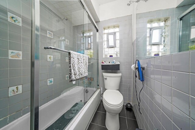 5512 W Wrightwood Ave, Chicago, IL 60639 - full bath with tile walls, bath / shower combo with glass door, and tile patterned flooring