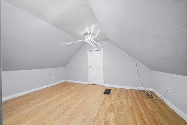 5512 W Wrightwood Ave, Chicago, IL 60639 - additional living space with vaulted ceiling and wood finished floors