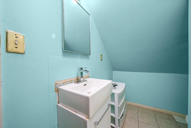 5512 W Wrightwood Ave, Chicago, IL 60639 - bathroom with lofted ceiling, vanity, and tile patterned floors