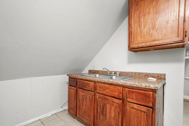 5512 W Wrightwood Ave, Chicago, IL 60639 - kitchen featuring lofted ceiling, light tile patterned floors, and brown cabinetry