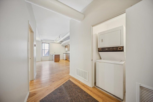 811 S Lytle St Unit 101, Chicago, IL 60607 - laundry room featuring estacked washer and dryer, light wood-type flooring, and baseboards