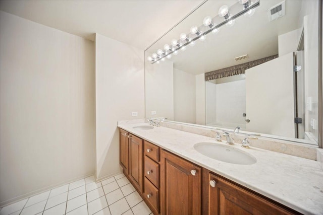 811 S Lytle St Unit 101, Chicago, IL 60607 - bathroom featuring double vanity, tile patterned flooring, baseboards, and a bathtub