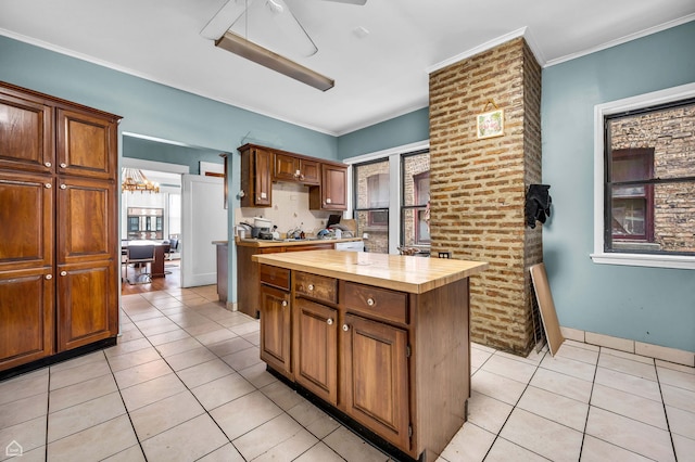 1347 E Hyde Park Blvd, Chicago, IL 60615 - kitchen featuring butcher block counters, light tile patterned floors, plenty of natural light, and ornamental molding