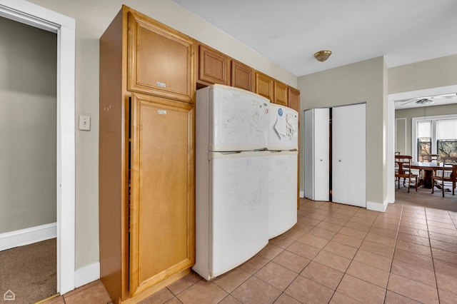 1347 E Hyde Park Blvd, Chicago, IL 60615 - kitchen with freestanding refrigerator, light tile patterned floors, and baseboards