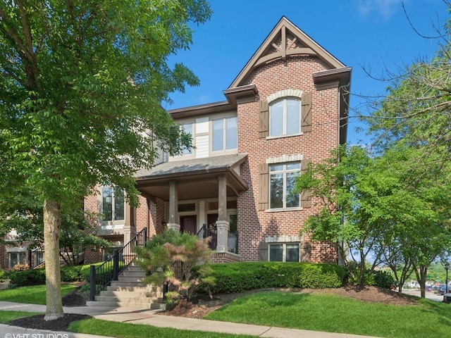 301 Brownstone Dr, Saint Charles, IL 60174 - view of front facade with brick siding, a porch, and a front lawn