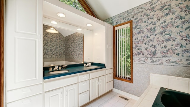2625 E Vera Ln, Crete, IL 60417 - bathroom featuring wallpapered walls, lofted ceiling, a garden tub, double vanity, and tile patterned flooring