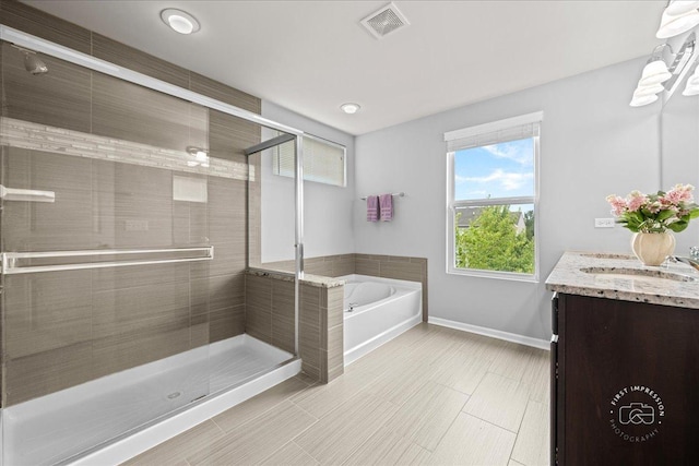 729 Hamilton Dr, South Elgin, IL 60177 - full bath with a garden tub, vanity, baseboards, and a shower stall