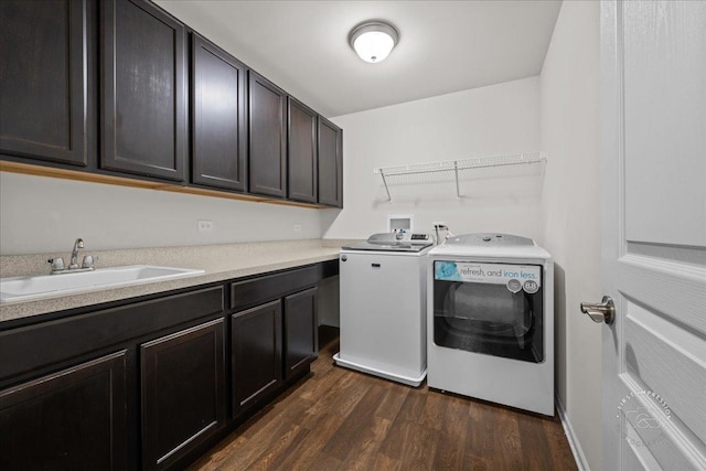 729 Hamilton Dr, South Elgin, IL 60177 - laundry room featuring independent washer and dryer, dark wood-type flooring, and cabinet space