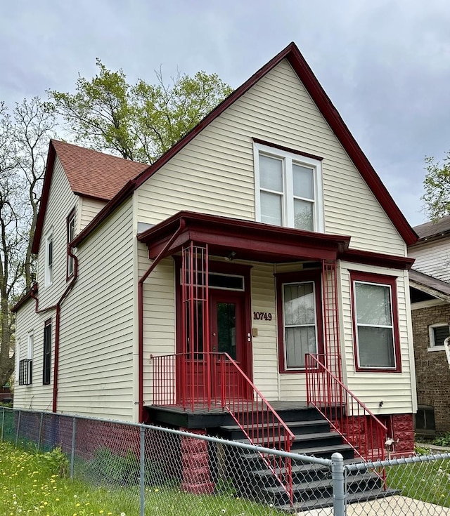 10749 S State St, Chicago, IL 60628 - view of front of home with a fenced front yard and a porch