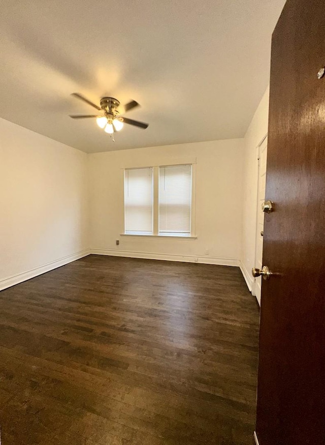 10749 S State St, Chicago, IL 60628 - empty room featuring dark wood-style floors, a ceiling fan, and baseboards