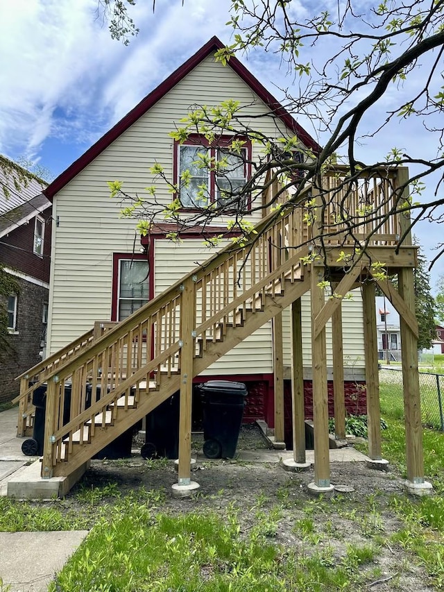 10749 S State St, Chicago, IL 60628 - view of property exterior with stairs, fence, and a deck