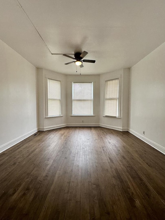 10749 S State St, Chicago, IL 60628 - unfurnished room featuring ceiling fan, dark wood-type flooring, and baseboards