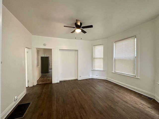 10749 S State St, Chicago, IL 60628 - unfurnished living room featuring dark wood-style floors, a ceiling fan, and baseboards