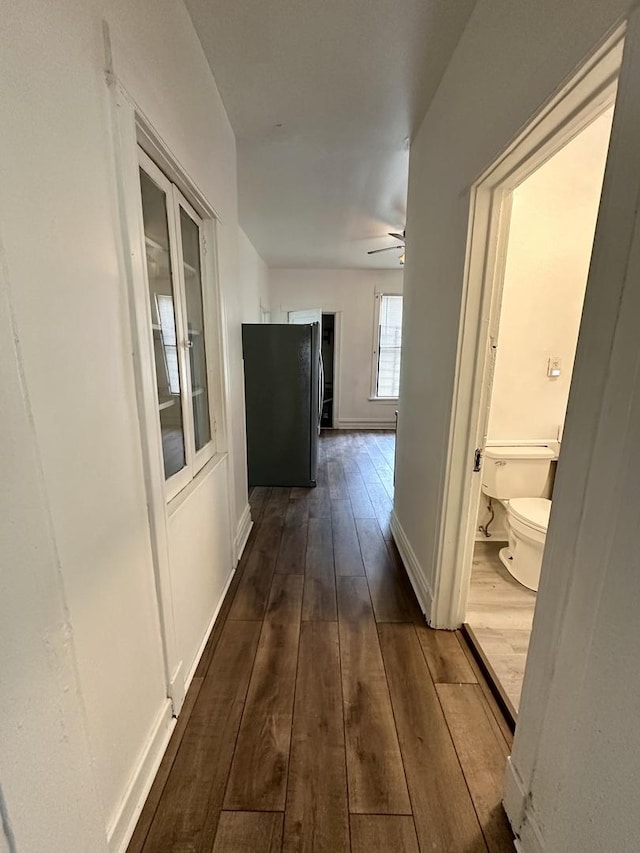 10749 S State St, Chicago, IL 60628 - corridor with dark wood-style flooring and baseboards