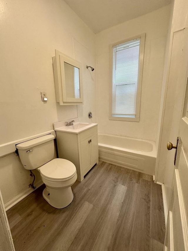 10749 S State St, Chicago, IL 60628 - bathroom with wood finished floors, toilet, shower / bathtub combination, vanity, and baseboards