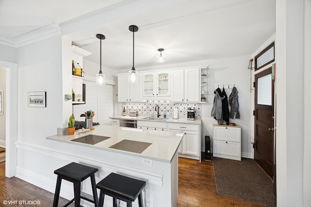 1112 Ontario St Unit 1E, Oak Park, IL 60302 - kitchen with a sink, stainless steel dishwasher, backsplash, a kitchen bar, and white cabinets