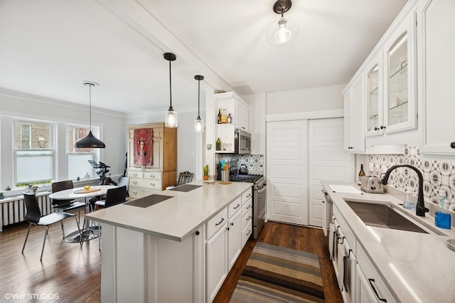 1112 Ontario St Unit 1E, Oak Park, IL 60302 - kitchen featuring stainless steel appliances, a sink, a peninsula, white cabinetry, and decorative backsplash