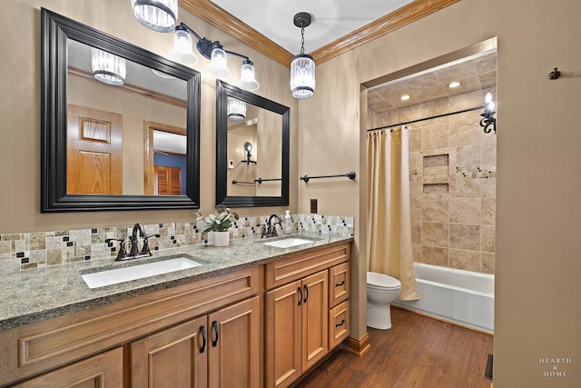 bathroom featuring toilet, ornamental molding, wood finished floors, double vanity, and shower / bath combination with curtain