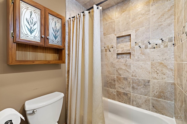 bathroom featuring toilet and shower / tub combo