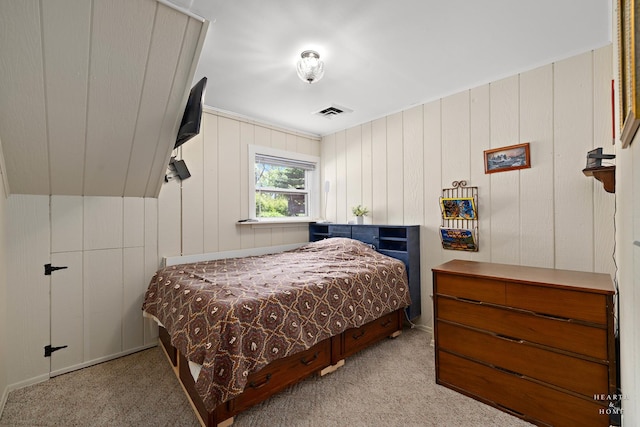 bedroom featuring carpet floors and wood walls