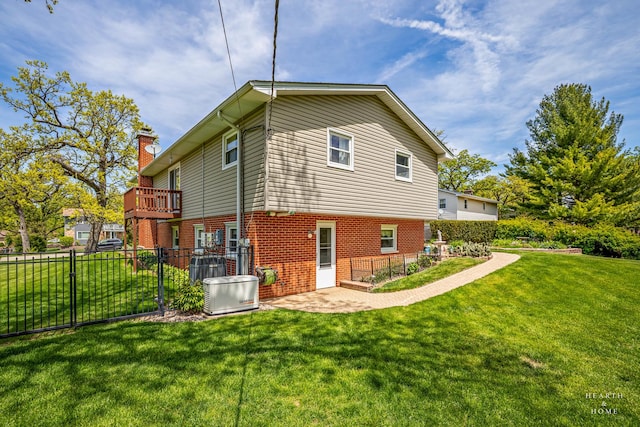 rear view of property with brick siding, a chimney, and a patio area