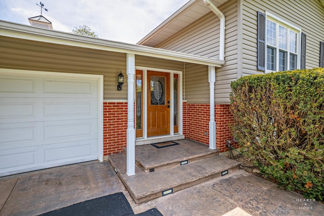 property entrance featuring brick siding and a garage
