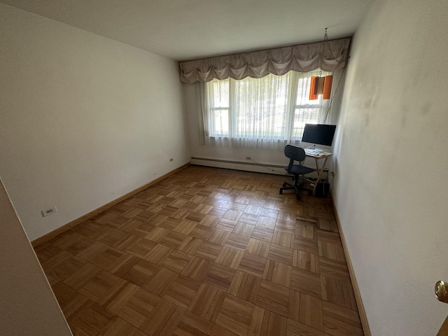 unfurnished office with a baseboard radiator and baseboards