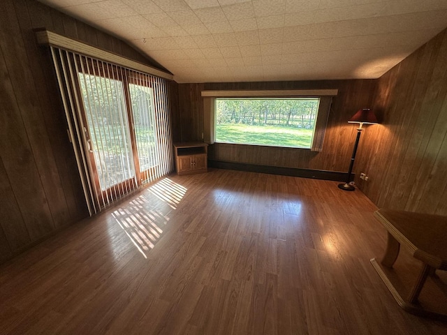 spare room with wood finished floors and wood walls