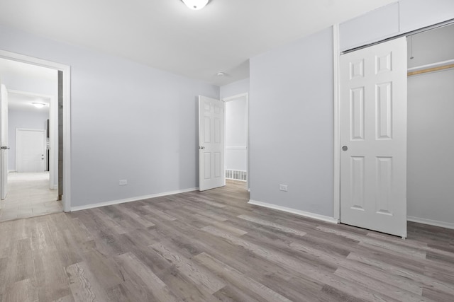 15503 Cherry St, South Holland, IL 60473 - unfurnished bedroom with light wood-type flooring, a closet, and baseboards
