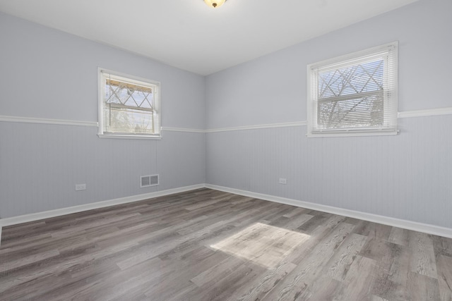 15503 Cherry St, South Holland, IL 60473 - unfurnished room with wainscoting, wood finished floors, and baseboards