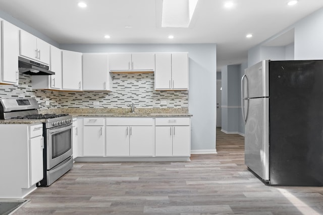 15503 Cherry St, South Holland, IL 60473 - kitchen with stainless steel appliances, under cabinet range hood, a sink, white cabinets, and light stone countertops
