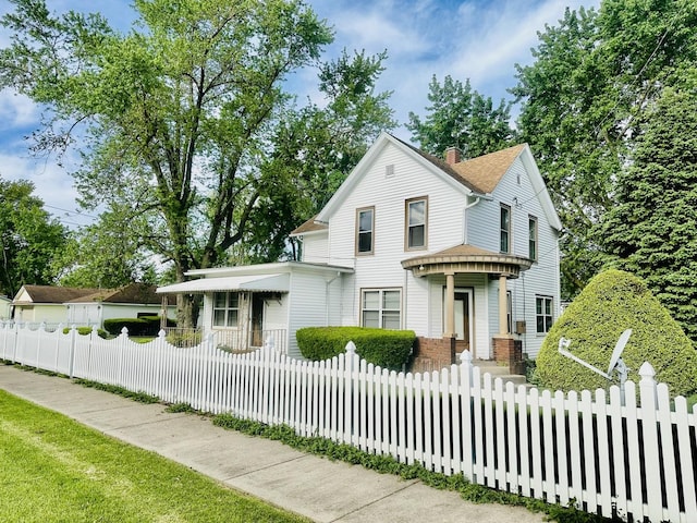 1115 E Wilson St, Streator, IL 61364 - view of front facade featuring a fenced front yard and a chimney