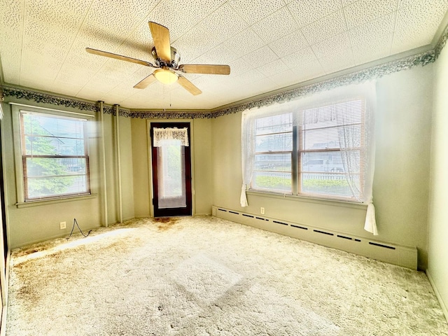 1115 E Wilson St, Streator, IL 61364 - carpeted spare room with baseboard heating and a ceiling fan