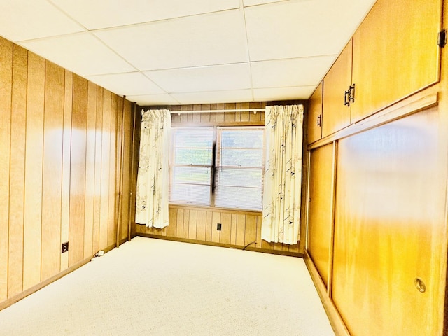 1115 E Wilson St, Streator, IL 61364 - carpeted empty room with wood walls and a paneled ceiling