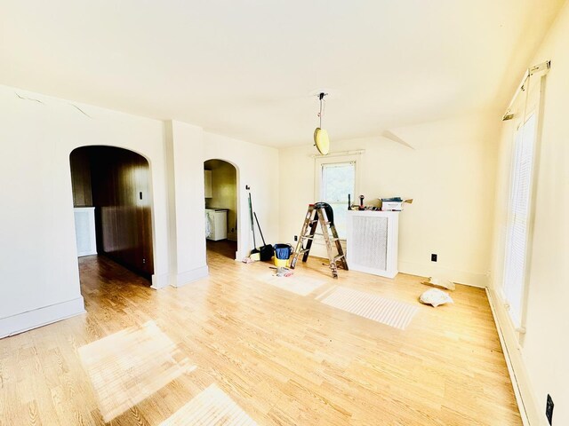 1115 E Wilson St, Streator, IL 61364 - spare room featuring arched walkways, wood finished floors, and baseboards