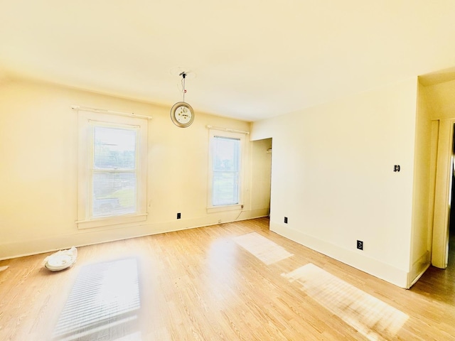 1115 E Wilson St, Streator, IL 61364 - unfurnished room featuring plenty of natural light, light wood-type flooring, and baseboards