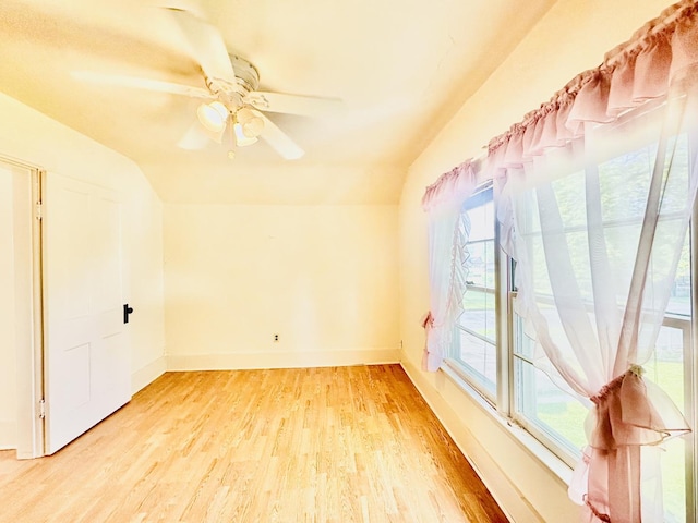 1115 E Wilson St, Streator, IL 61364 - empty room featuring light wood finished floors, lofted ceiling, baseboards, and a ceiling fan
