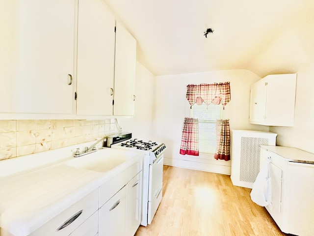 1115 E Wilson St, Streator, IL 61364 - kitchen with white gas range oven, light countertops, white cabinets, and light wood-type flooring