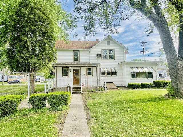 1115 E Wilson St, Streator, IL 61364 - traditional-style home with a front yard, a chimney, and covered porch