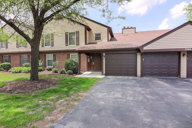 2169 Sunderland Ct Unit 101B, Naperville, IL 60565 - view of front of home with brick siding, asphalt driveway, an attached garage, a chimney, and roof with shingles