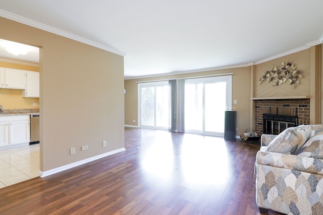 2169 Sunderland Ct Unit 101B, Naperville, IL 60565 - living area featuring wood finished floors, a brick fireplace, crown molding, and baseboards