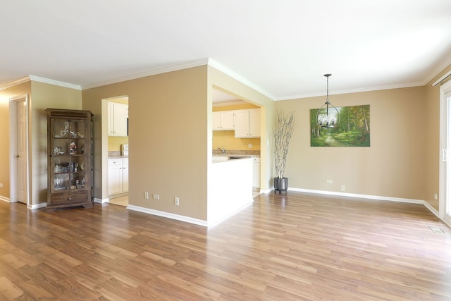 2169 Sunderland Ct Unit 101B, Naperville, IL 60565 - unfurnished living room with light wood-type flooring, baseboards, crown molding, and a chandelier