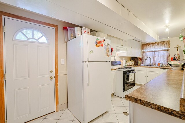 1703 W Robbie Ln, Mount Prospect, IL 60056 - kitchen featuring gas range, freestanding refrigerator, under cabinet range hood, light tile patterned flooring, and a sink