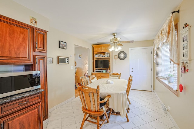 1703 W Robbie Ln, Mount Prospect, IL 60056 - dining room featuring ceiling fan, light tile patterned floors, and baseboards