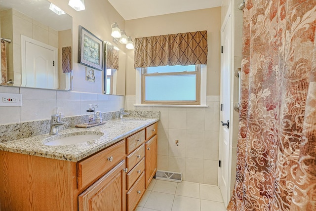 1703 W Robbie Ln, Mount Prospect, IL 60056 - bathroom with tile walls, tile patterned flooring, double vanity, and a wainscoted wall